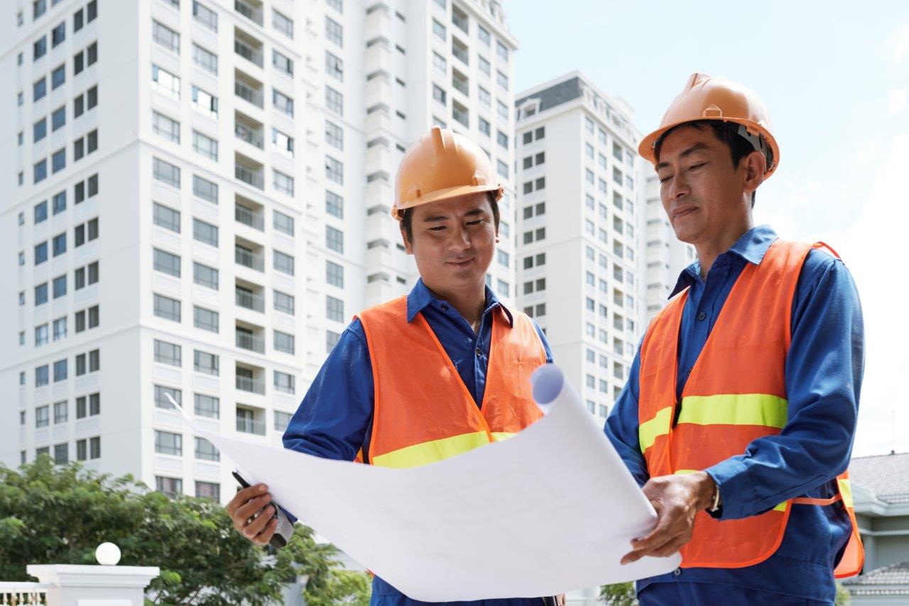 General construction site with workers and building framework