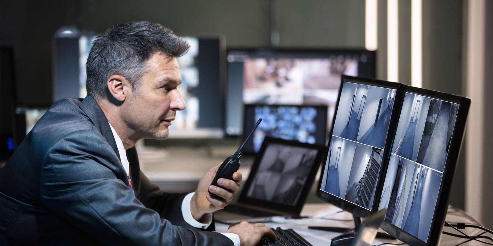 Security professional installing CCTV camera system in a building