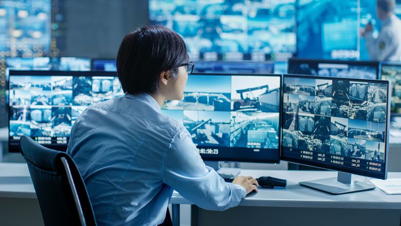 Modern security control room with multiple monitoring screens